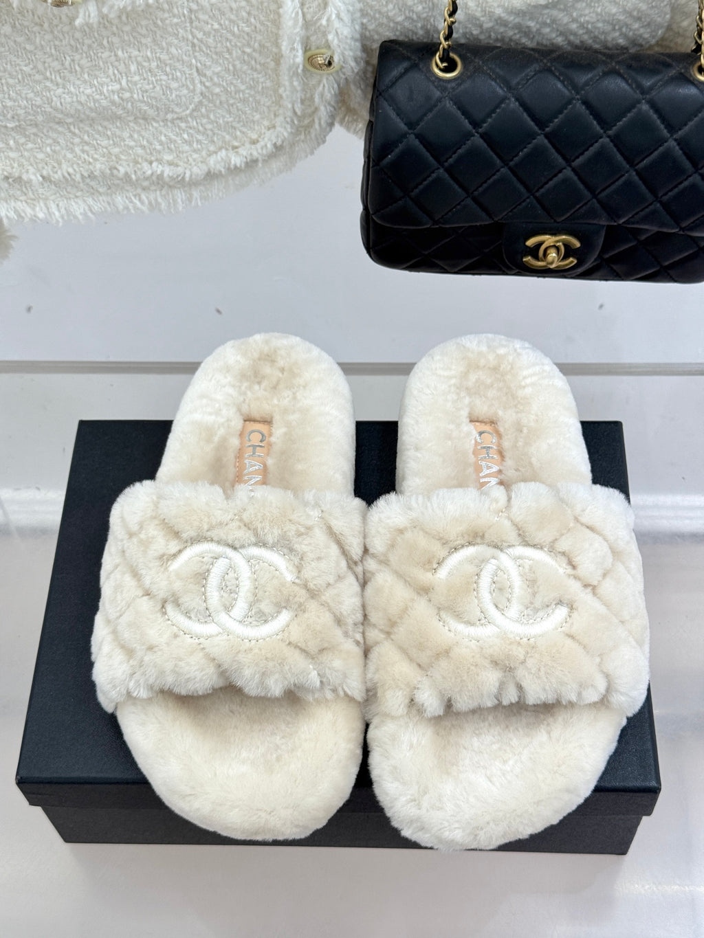 Cream plush slide sandals with double-C logo, shown on black box