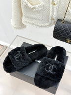 Pair of dark faux-fur Chanel slides with front CC emblems, on gray shoe box