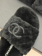 Close-up of dark faux-fur Chanel slide front with embroidered CC emblem