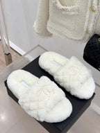 Pair of white faux-fur mules with Chanel logo embroidery on black box