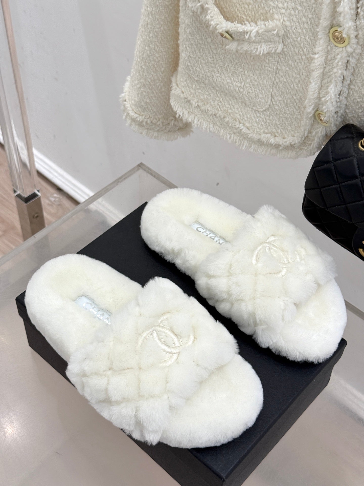 Pair of white faux-fur mules with Chanel logo embroidery on black box