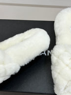 White faux-fur mule with Chanel logo detail on black box