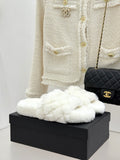 White faux-fur slide mules with Chanel logo on black box