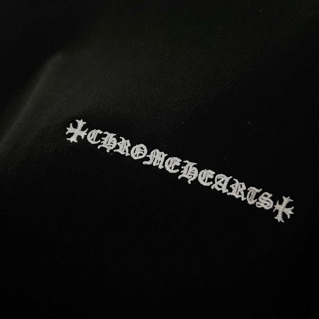 Black sweatshirt with embroidered logo text across the chest