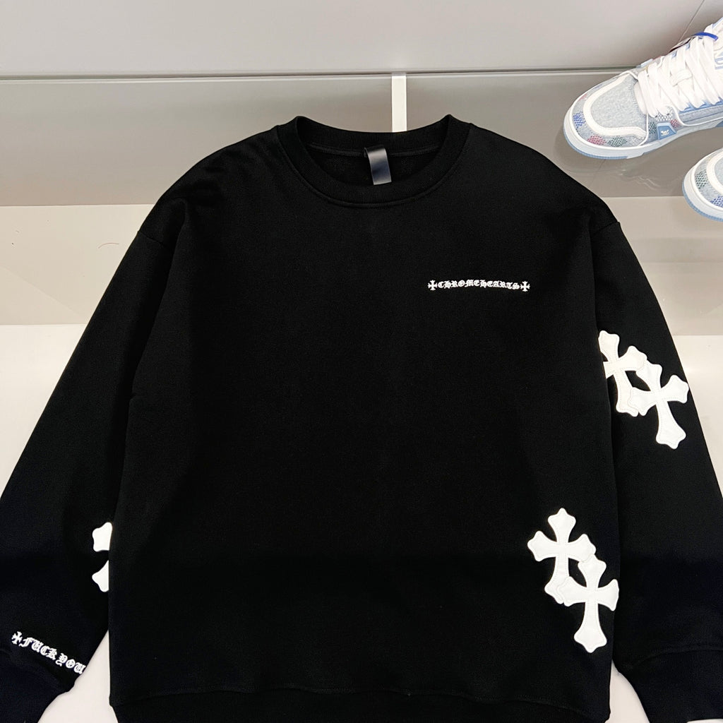Black long-sleeve sweatshirt with white cross appliques and small chest logo