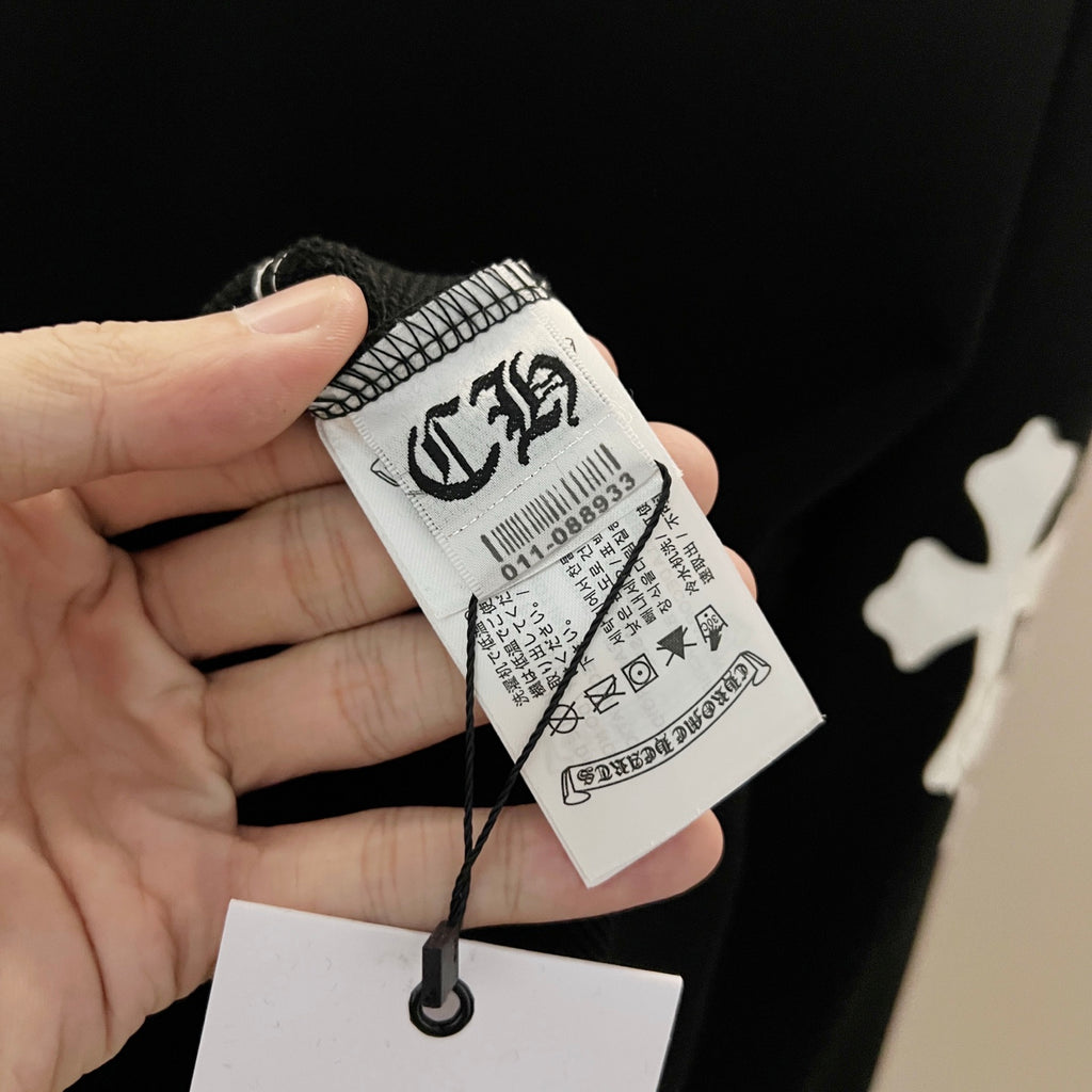 Black sweatshirt with size tag and care label on the sleeve