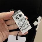 Black sweatshirt with size tag and care label on the sleeve