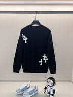 Black crewneck sweatshirt with white cross appliques on back and sleeves