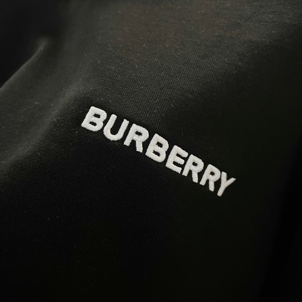 Navy sweatshirt fabric with embroidered BURBERRY lettering across the chest