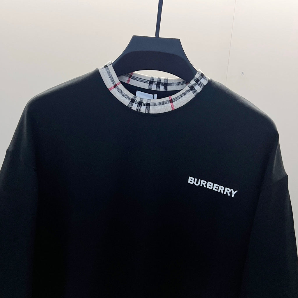 Navy crewneck sweatshirt close-up with Nova Check ribbed collar and Burberry logo on chest