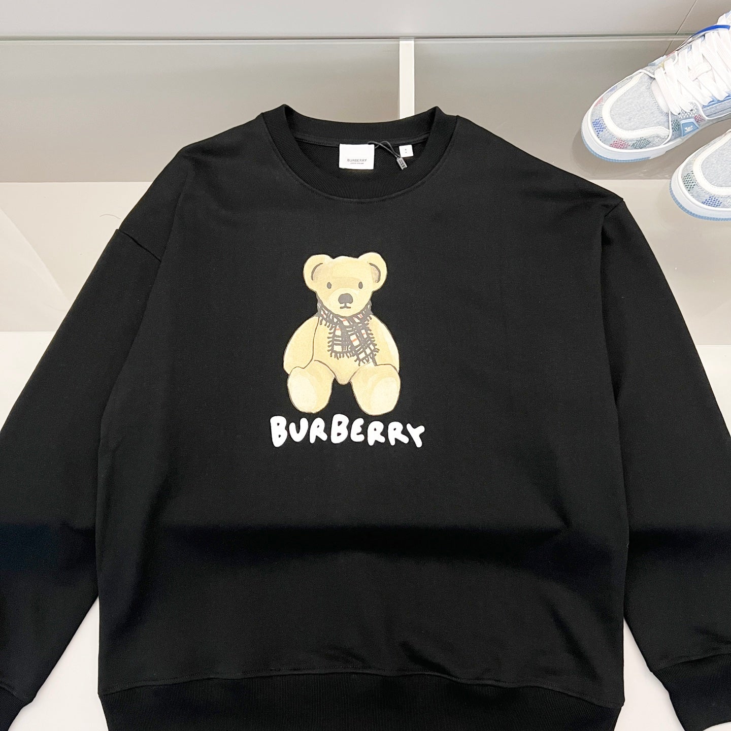 Kids long-sleeve sweatshirt, dark color, teddy bear graphic and logo on chest