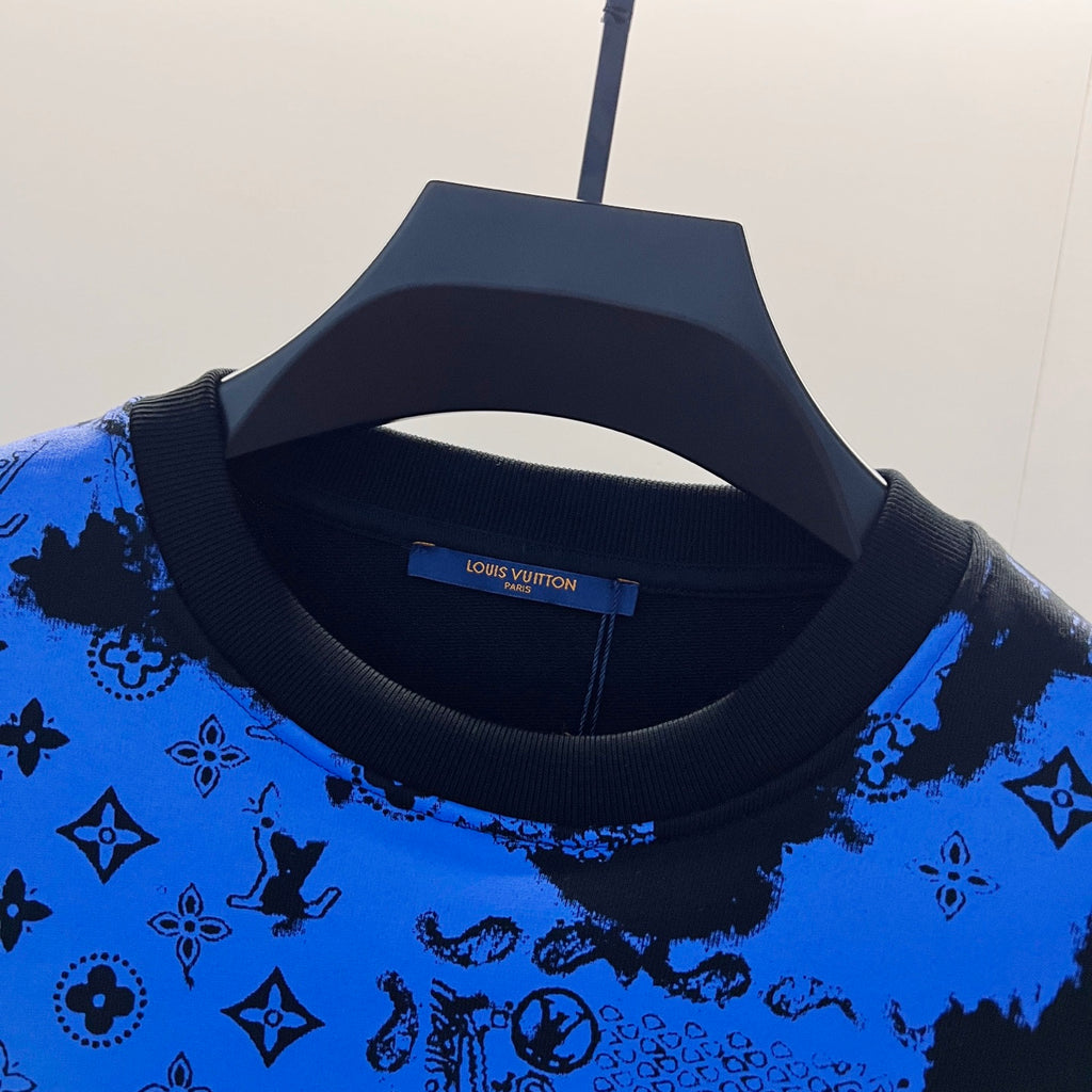 Crew-neck sweatshirt close-up with blue-and-black logo-style pattern on knit
