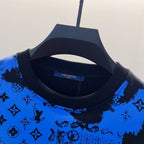 Crew-neck sweatshirt close-up with blue-and-black logo-style pattern on knit
