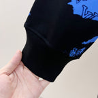 Ribbed cuff and hem detail on blue-and-black sweatshirt sleeve