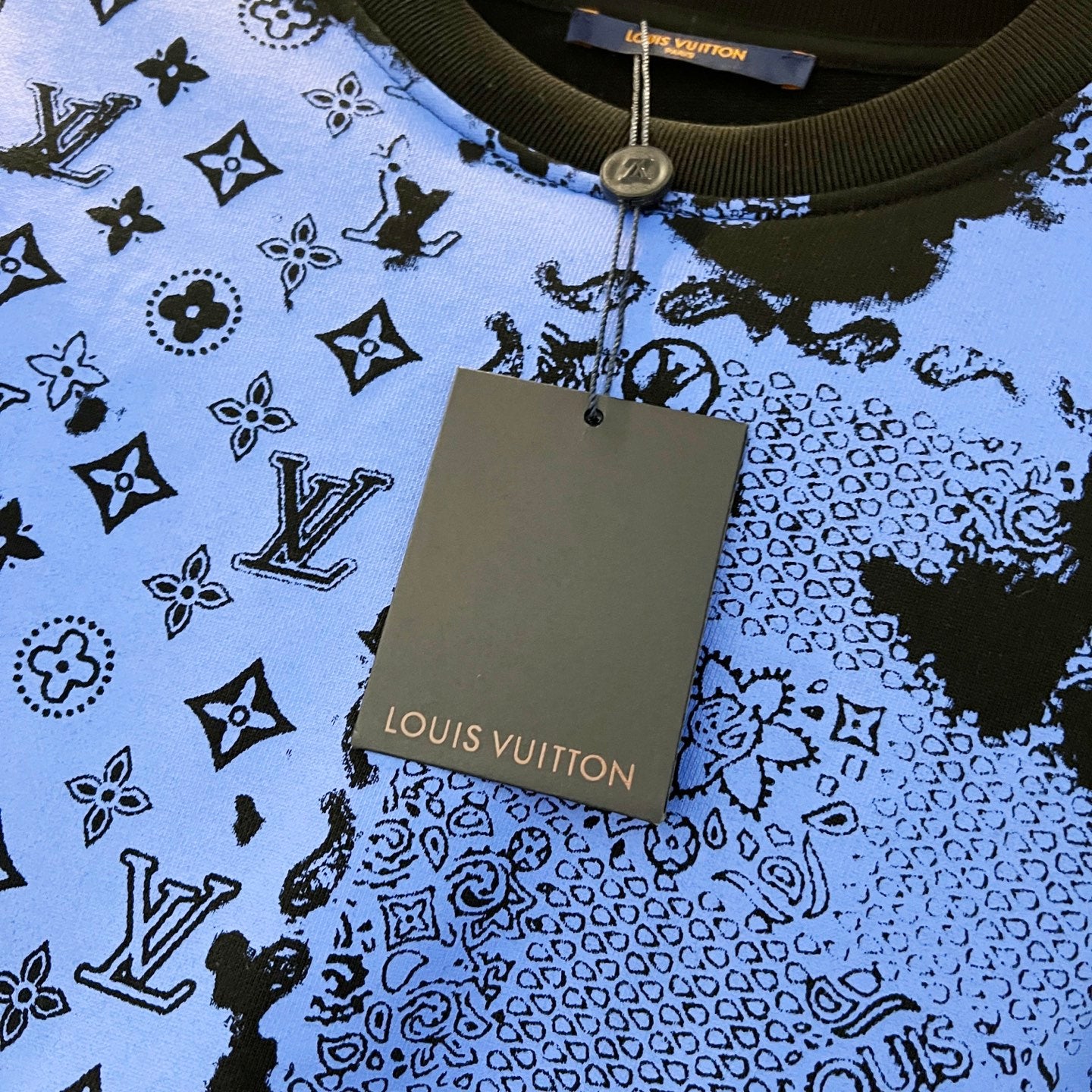 Louis Vuitton tag on blue-and-black sweatshirt neckline with ribbed trim
