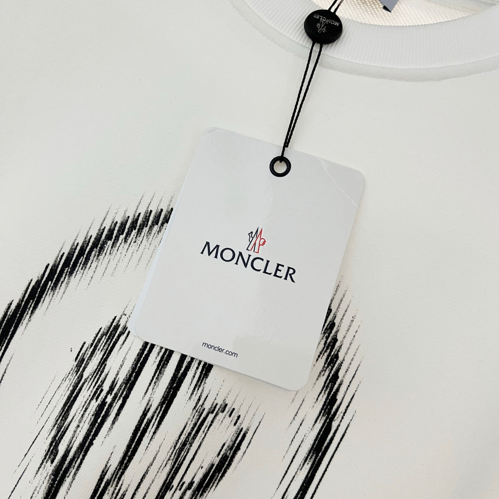 White sweatshirt neckline with hanging tag and MONCLER branding