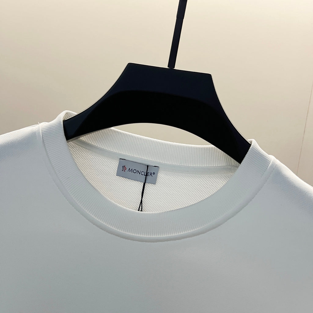 Moncler white crew-neck sweatshirt close-up, ribbed collar and brand label