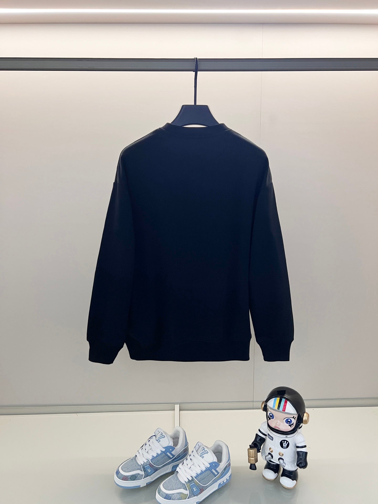 Dark navy crewneck sweatshirt with long sleeves, plain back.