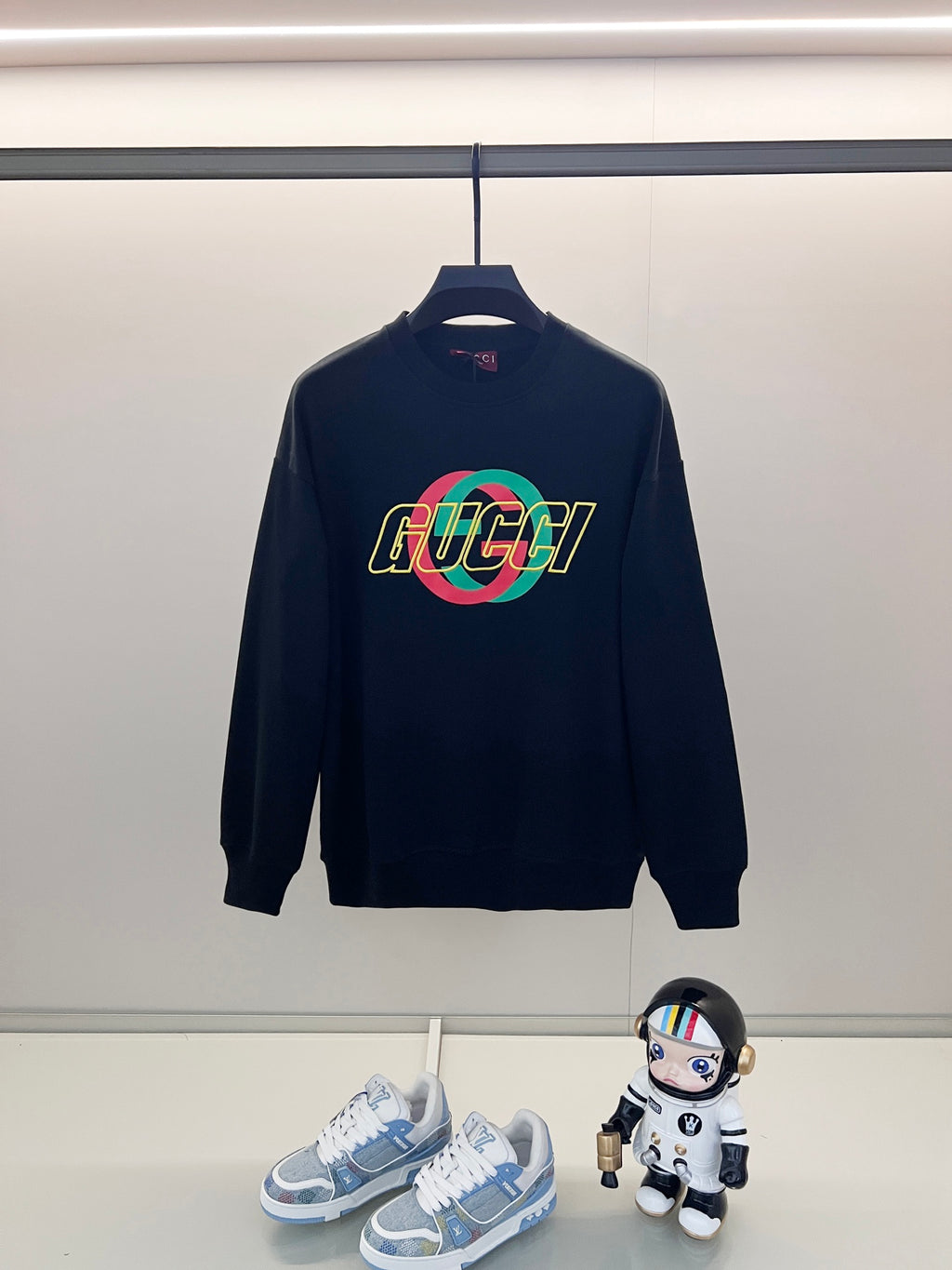 Dark navy sweatshirt with multicolor GUCCI logo on chest, crew neck.