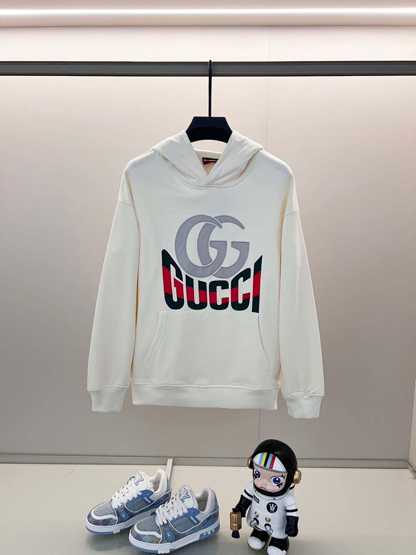White Gucci long-sleeve hoodie with front logo print and pullover hood