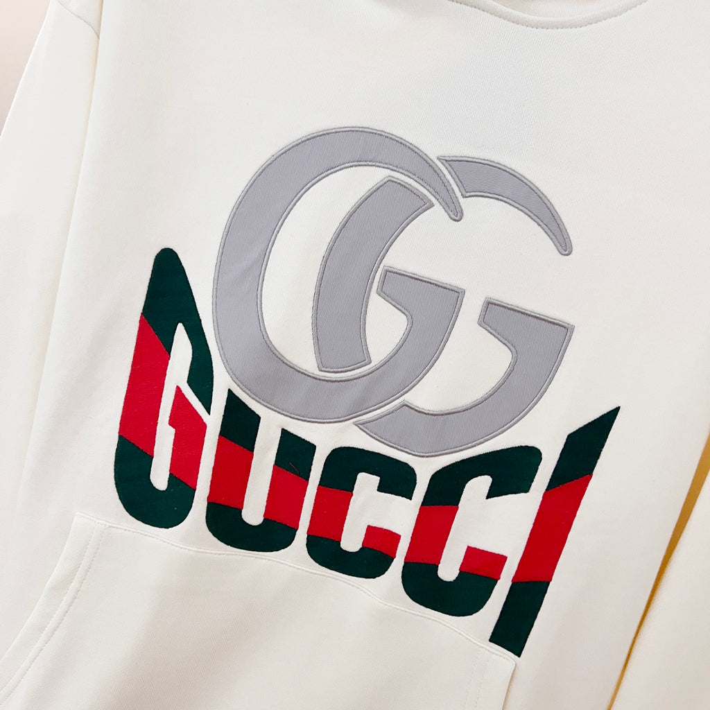 White Gucci hoodie chest logo with large grey G and multicolor Gucci text