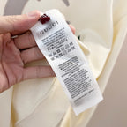 White Gucci hoodie care label on inside collar
