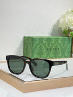 Gucci cat-eye sunglasses with tortoiseshell arms and dark tinted lenses