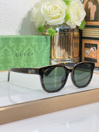 Gucci sunglasses with dark tortoiseshell frames and tinted lenses