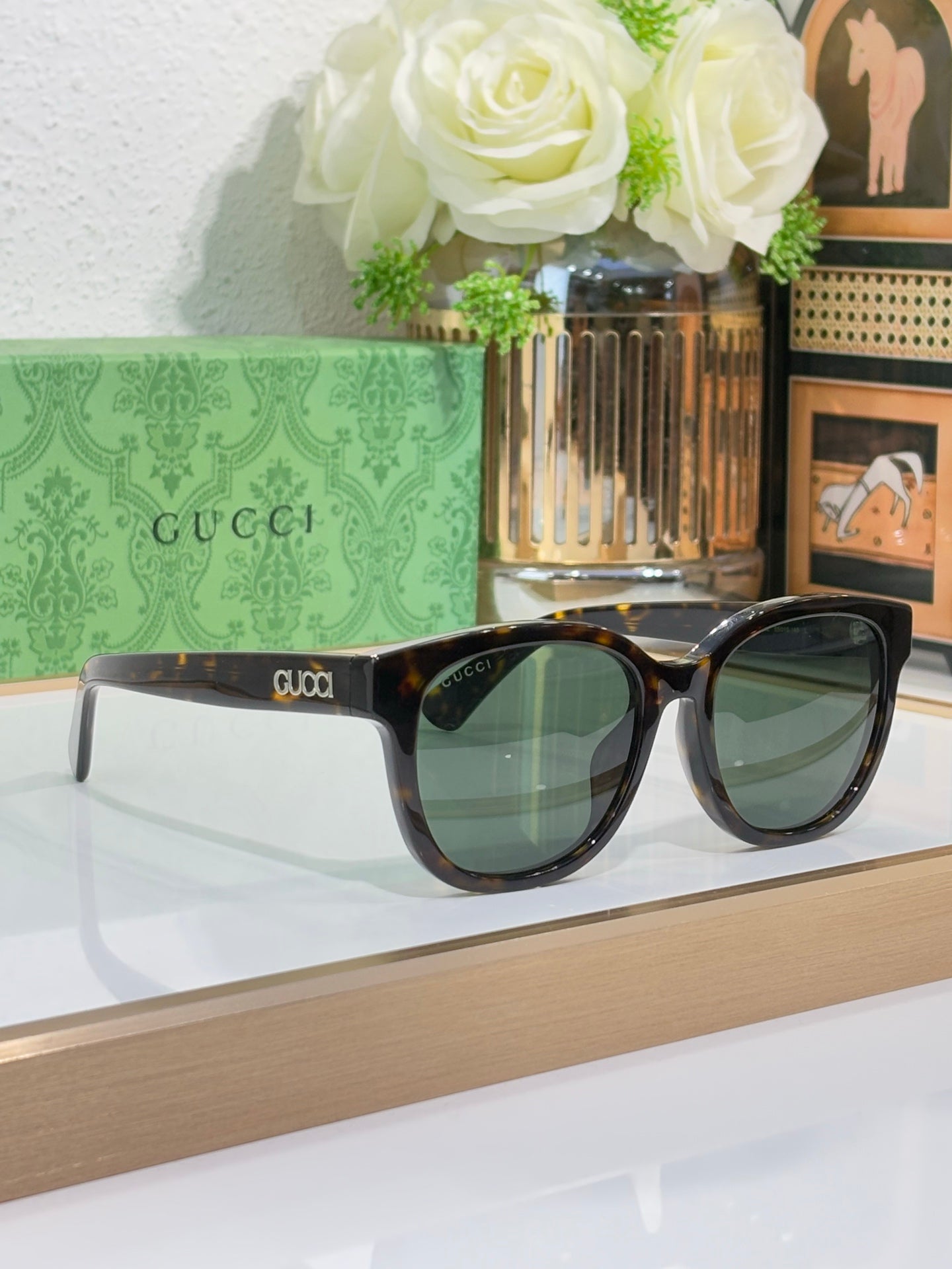 Gucci sunglasses with dark tortoiseshell frames and tinted lenses