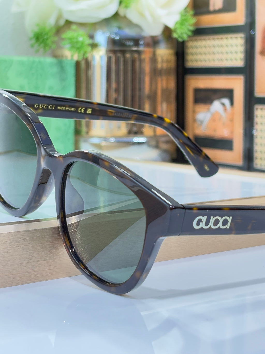 Gucci sunglasses side profile with dark tinted lenses and tortoiseshell arms