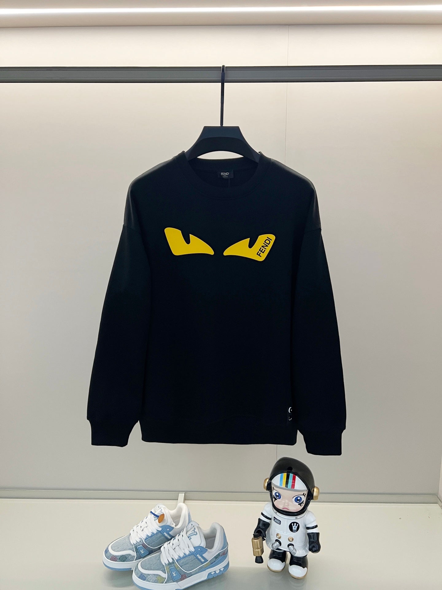 Black Fendi sweatshirt with yellow graphic logo on front