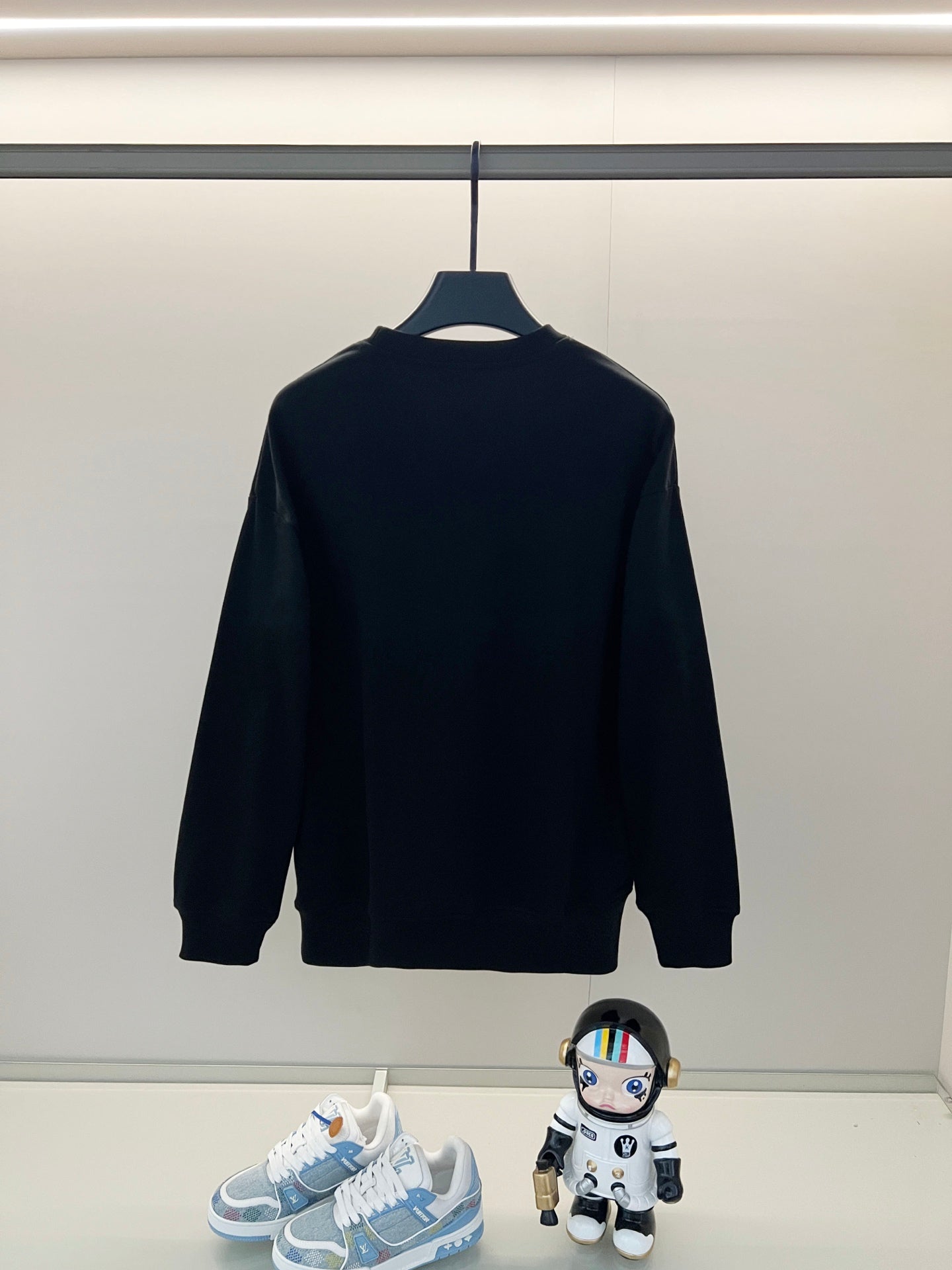 Black Fendi sweatshirt hanging with yellow graphic logo