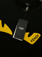 Black Fendi sweatshirt with yellow graphic logo and hanging tag