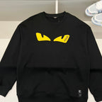 Black Fendi sweatshirt front with yellow graphic logo patch