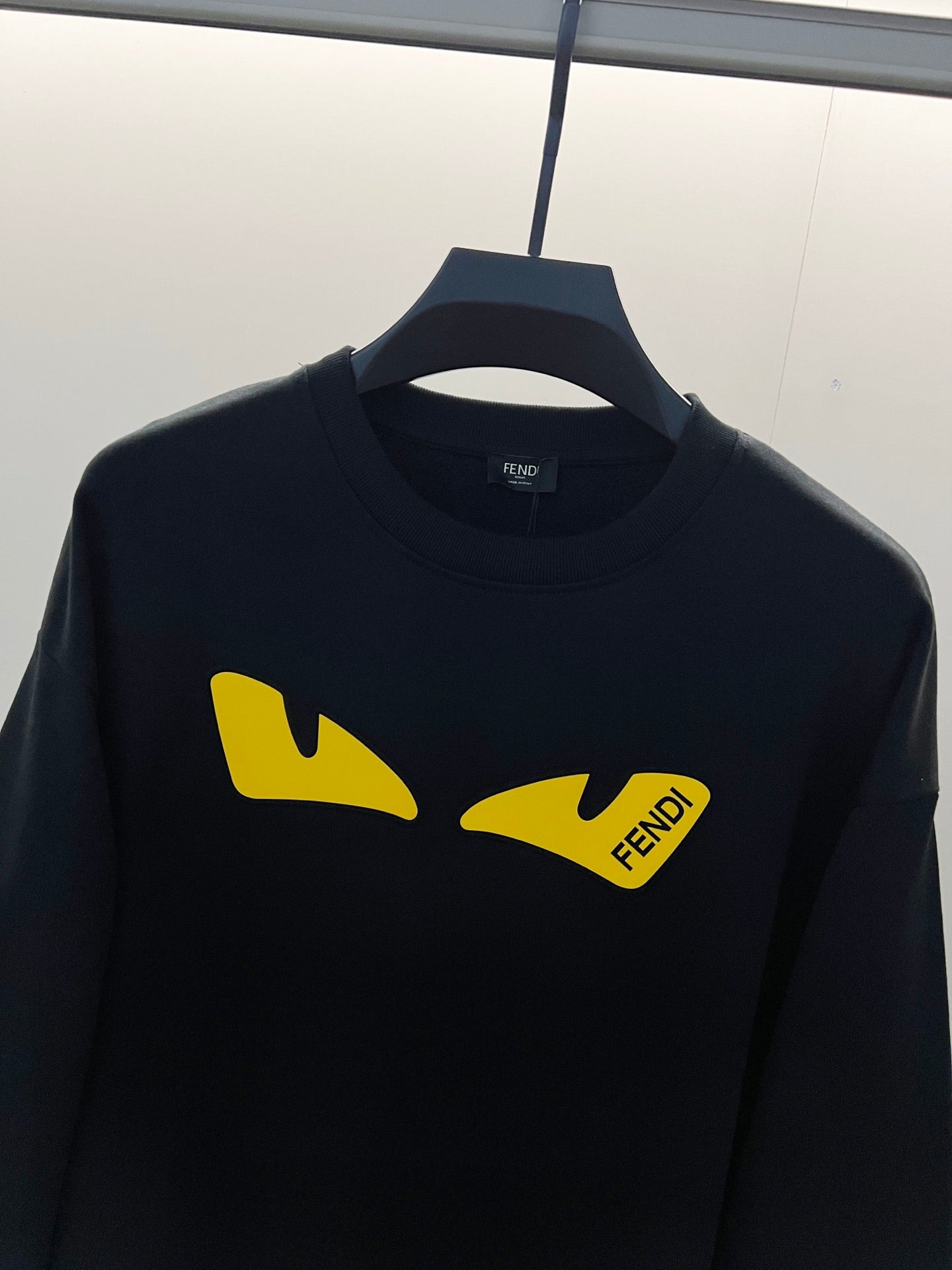 Black Fendi sweatshirt front with yellow graphic logo