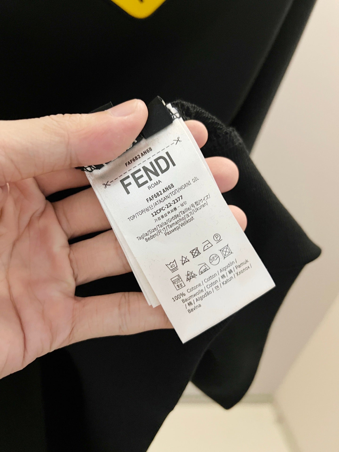 Black Fendi sweatshirt care tag attached inside collar