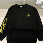 Black long-sleeve crewneck shirt with neon yellow cross detail
