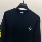 Black long-sleeve shirt with neon yellow cross chest embroidery