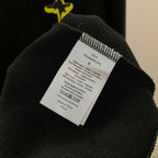 Black garment with white care label on the inside