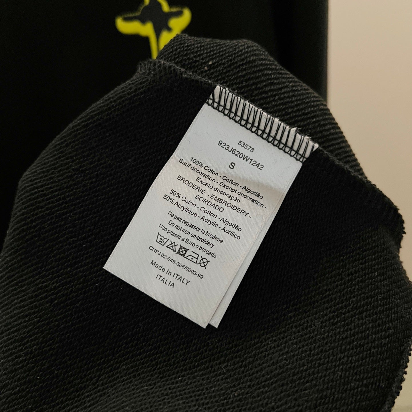 Black garment with white care label on the inside