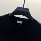 Black ribbed crewneck collar with small brand tag