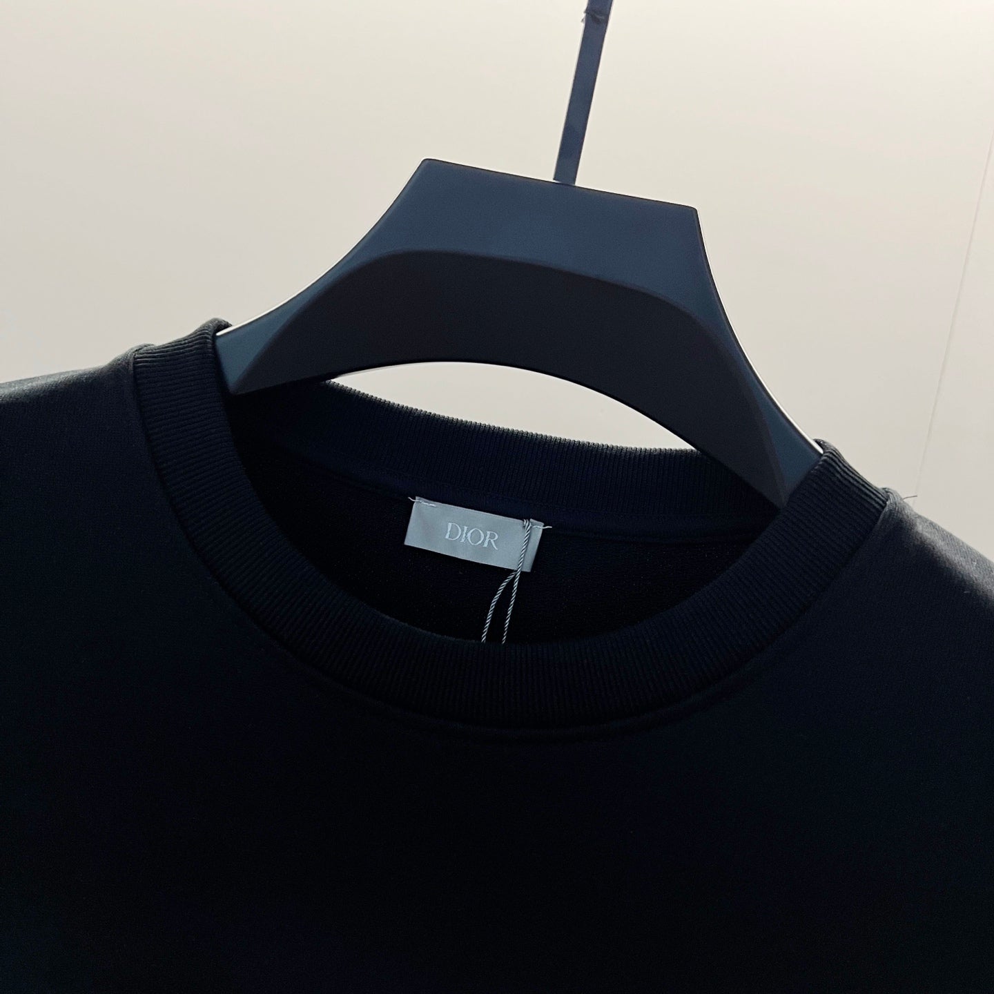Black ribbed crewneck collar with small brand tag