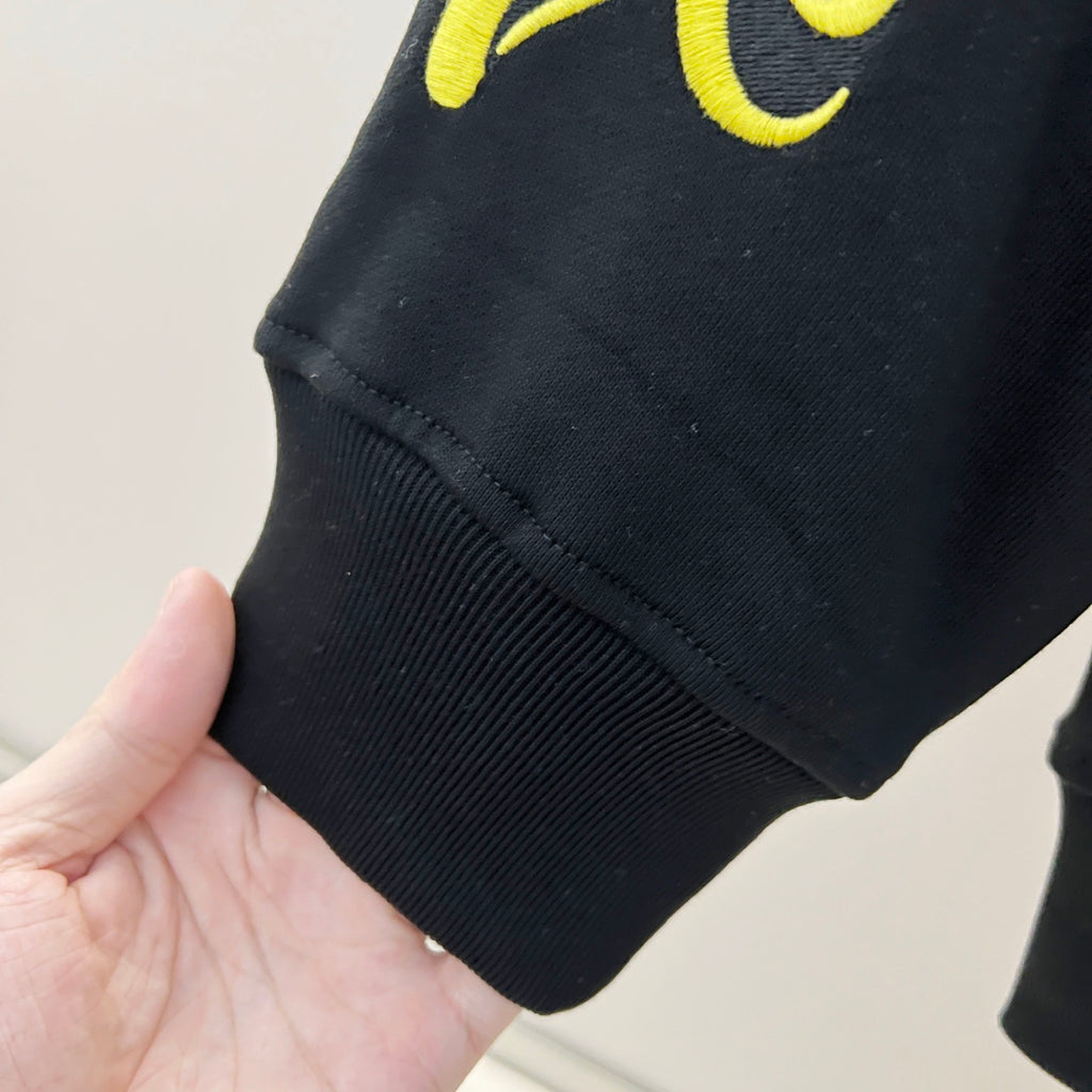 Black ribbed-knit sleeve cuff and straight hem
