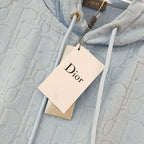 Light blue hoodie with allover logo texture and attached Dior-branded hang tag