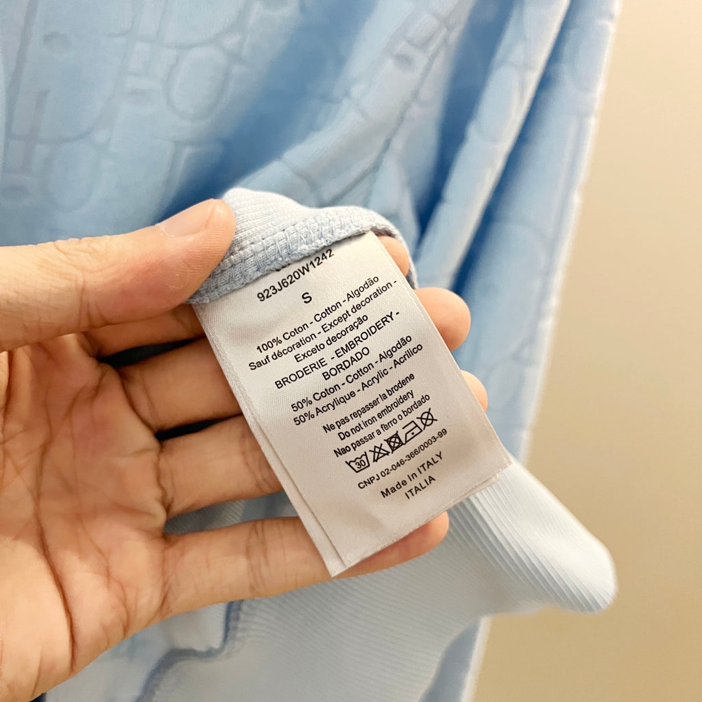 White care label on light blue hoodie interior
