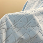 Light blue hoodie fabric with raised allover logo pattern texture