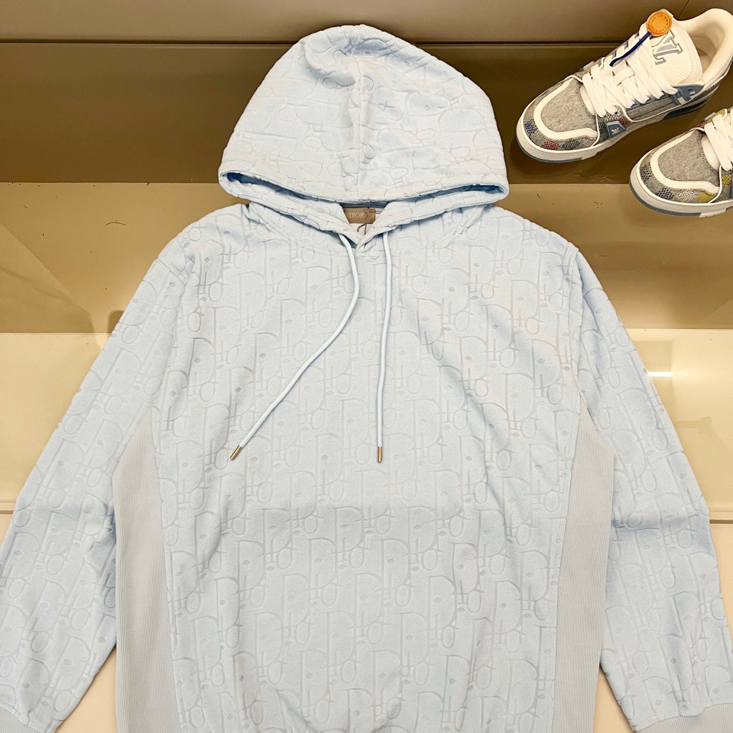 Light blue logo-pattern hoodie with drawstring hood and front kangaroo pocket