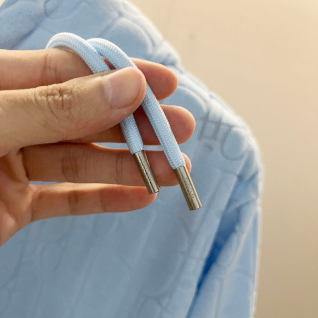 Light blue hoodie drawstrings with metal aglet tips