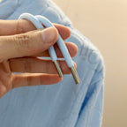 Light blue hoodie drawstrings with metal aglet tips