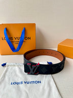 Louis Vuitton belt with dark monogram strap and red-accent LV buckle, brown back